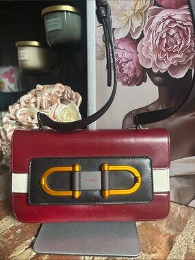 Furla Bellaria Mini Crossbody bag in a burgundy, white, and black